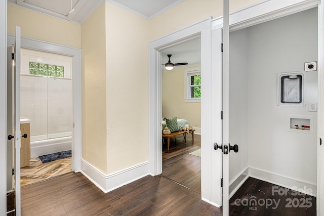 hallway with dark hardwood / wood-style flooring and ornamental molding