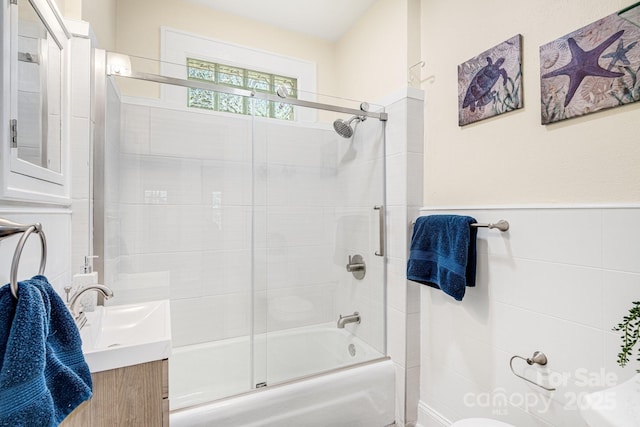 full bathroom featuring vanity, toilet, and combined bath / shower with glass door