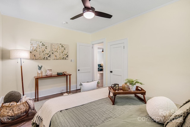 bedroom with hardwood / wood-style floors, ceiling fan, and ornamental molding