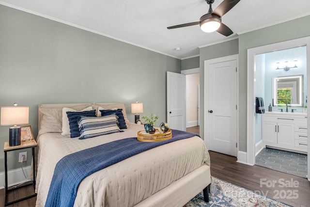 bedroom with dark wood-type flooring, ensuite bathroom, sink, crown molding, and ceiling fan