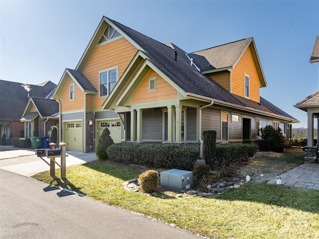 view of front of property featuring a garage and a front yard