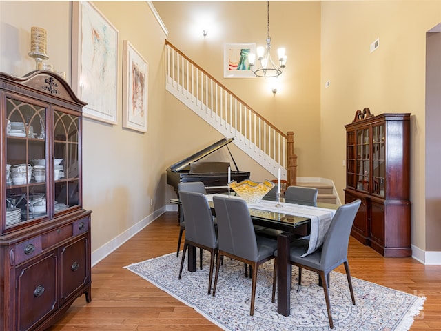 dining area with a chandelier and light hardwood / wood-style flooring