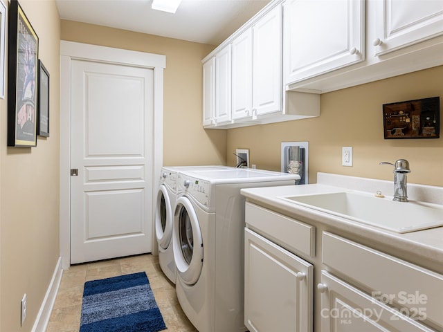 laundry room featuring cabinets, light tile patterned floors, separate washer and dryer, and sink