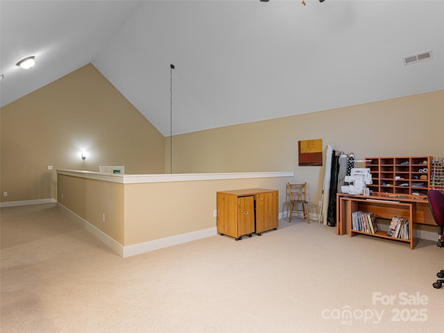 interior space with carpet floors and vaulted ceiling