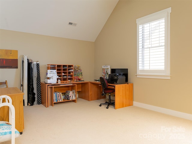 carpeted home office featuring lofted ceiling and a wealth of natural light