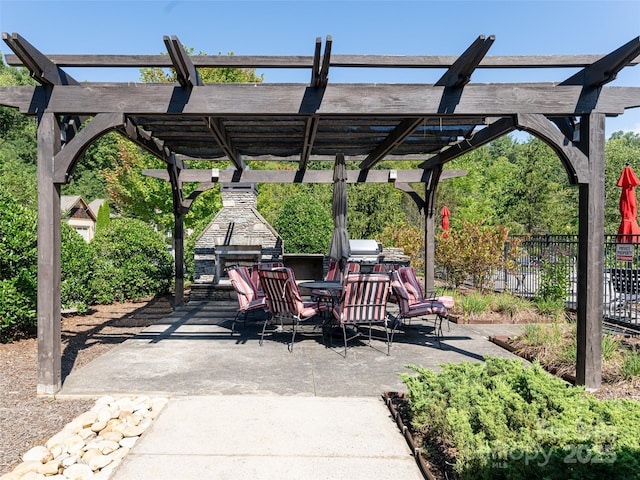 view of patio featuring an outdoor stone fireplace and a pergola