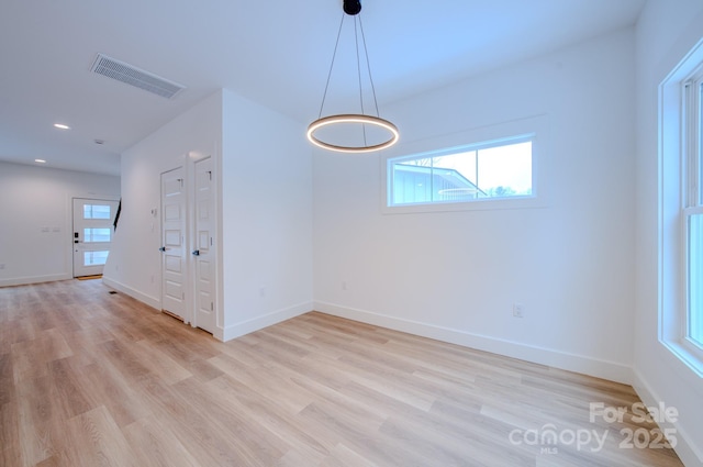 unfurnished dining area with light hardwood / wood-style flooring