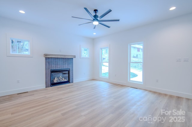 unfurnished living room featuring ceiling fan and light hardwood / wood-style floors