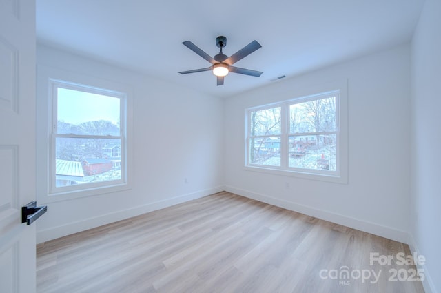 spare room featuring light wood-type flooring and ceiling fan