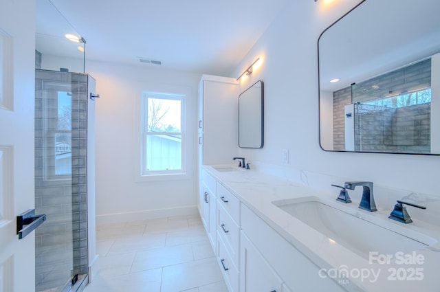 bathroom featuring tile patterned flooring, vanity, and an enclosed shower