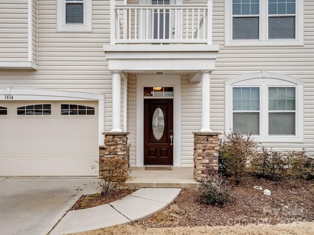 doorway to property with a balcony and a garage