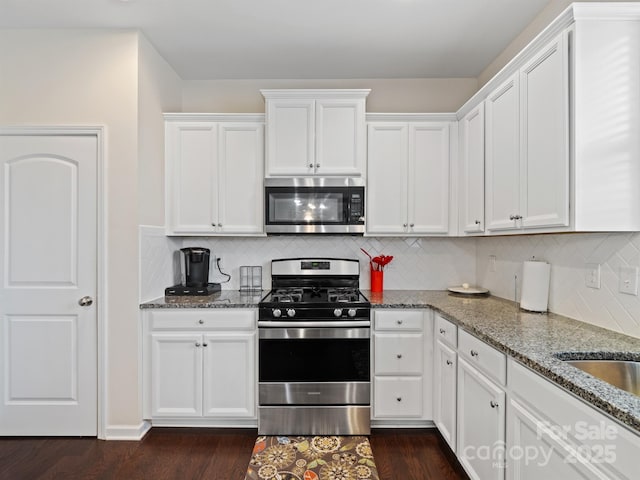 kitchen featuring light stone counters, white cabinetry, and appliances with stainless steel finishes