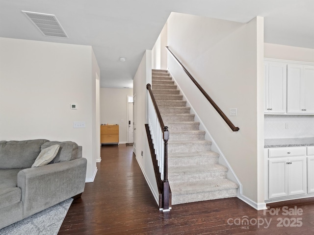 stairway with hardwood / wood-style floors