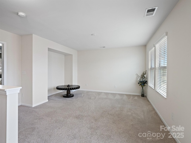 spare room featuring light colored carpet