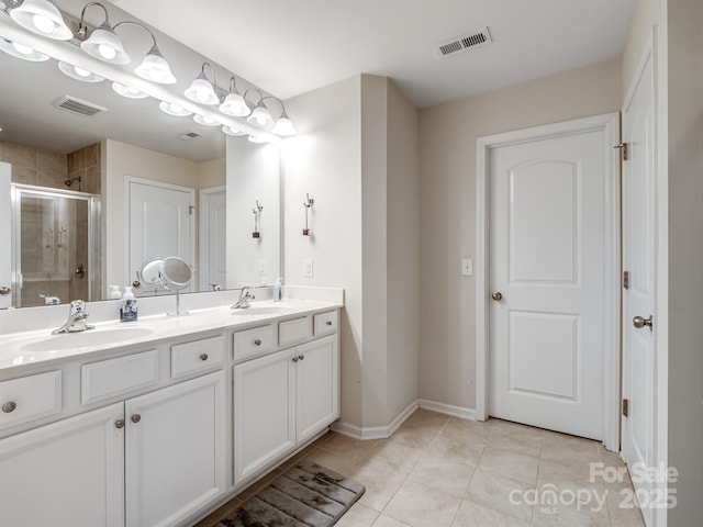 bathroom featuring tile patterned flooring, vanity, and an enclosed shower