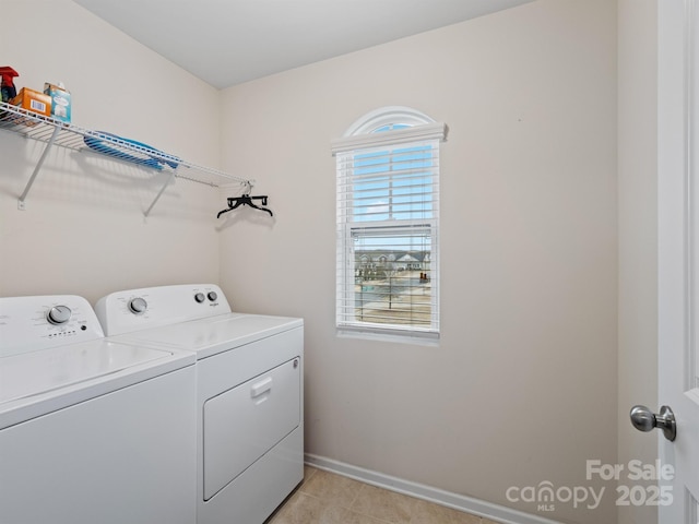 clothes washing area featuring light tile patterned floors and separate washer and dryer