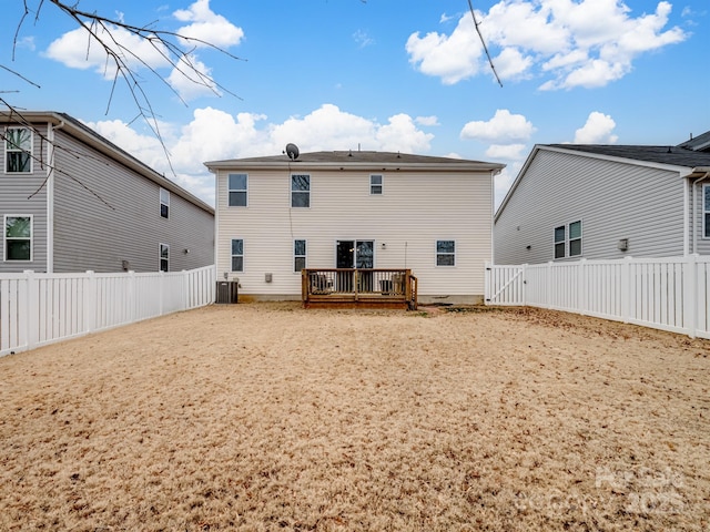 rear view of property with central AC unit and a deck