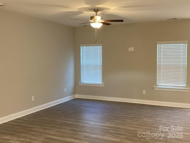 empty room featuring ceiling fan and dark wood-type flooring