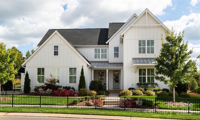 modern farmhouse style home featuring a front lawn