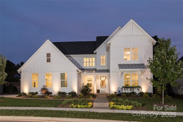 modern inspired farmhouse with a front lawn