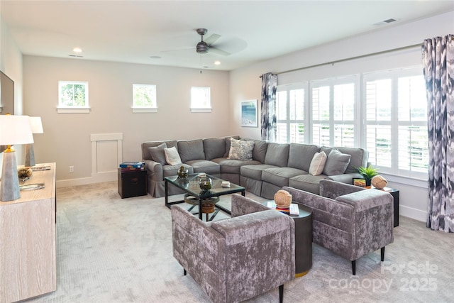 living room with light colored carpet and ceiling fan