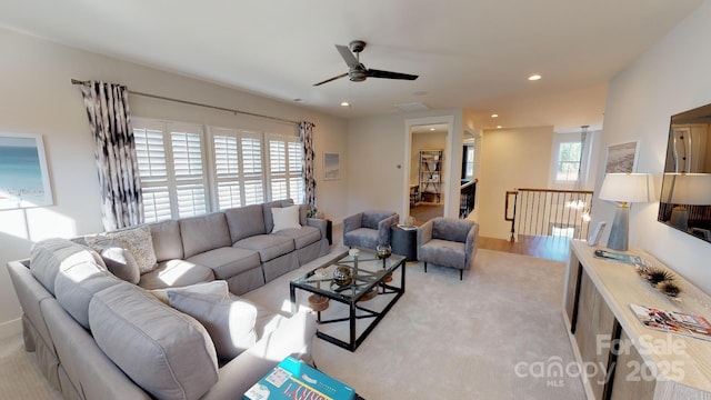 living room with light carpet, ceiling fan, and plenty of natural light