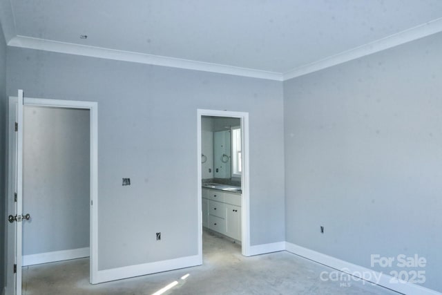 unfurnished bedroom featuring ensuite bathroom and crown molding