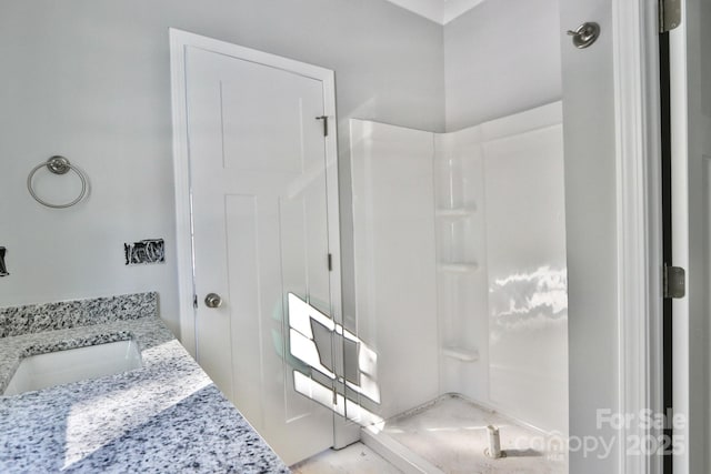 bathroom featuring vanity and a shower