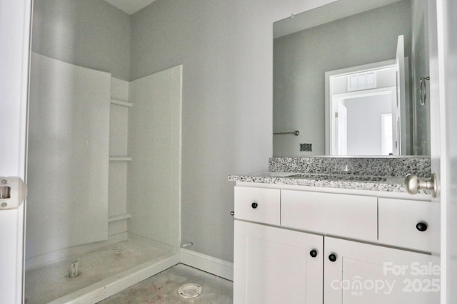 bathroom with walk in shower and vanity