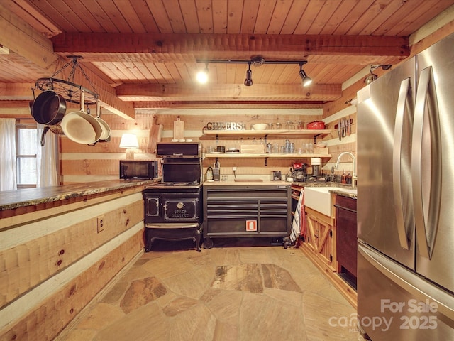 kitchen featuring stainless steel refrigerator, wood ceiling, beam ceiling, and sink