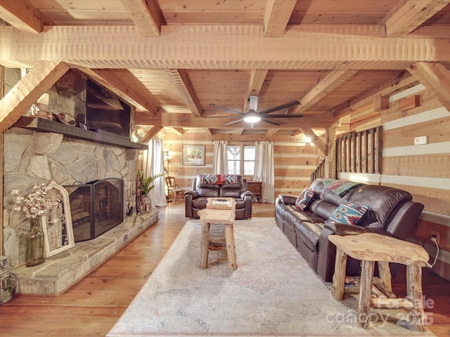 living room featuring hardwood / wood-style flooring, wooden walls, a fireplace, and wooden ceiling