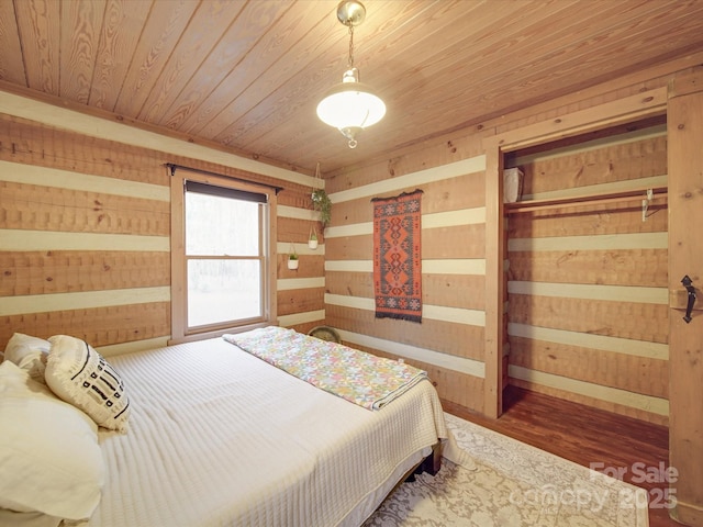 bedroom featuring wooden walls, wooden ceiling, and dark hardwood / wood-style floors