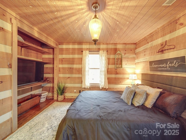 bedroom featuring wood-type flooring, wood ceiling, and wood walls