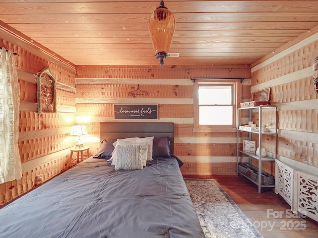 unfurnished bedroom with wood ceiling and wooden walls