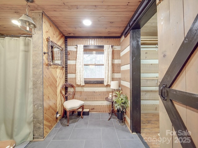 corridor featuring dark tile patterned flooring, wooden ceiling, and wood walls