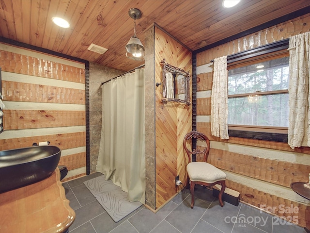 bathroom featuring wood ceiling, a shower with curtain, tile patterned flooring, and wood walls