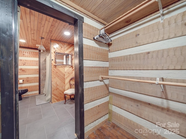 interior space with wood ceiling and wooden walls