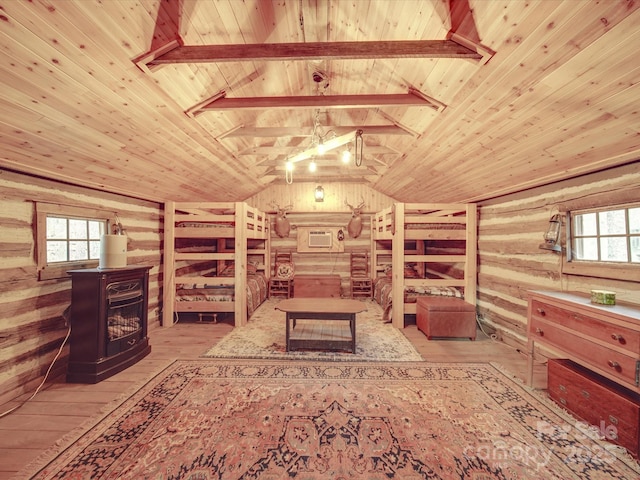 interior space featuring wood walls, a wood stove, vaulted ceiling with beams, wooden ceiling, and light wood-type flooring