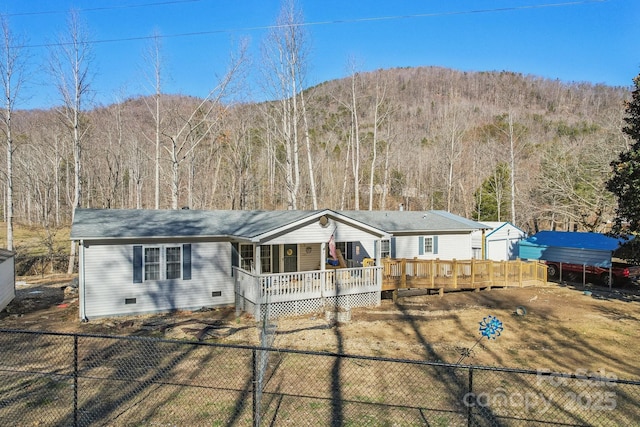 ranch-style house featuring a deck with mountain view