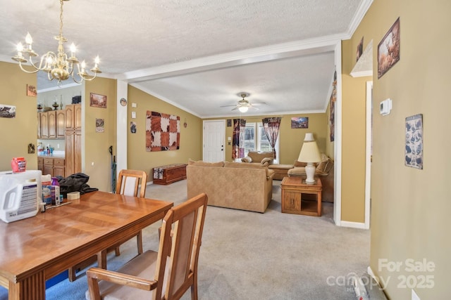 dining room with light colored carpet, ornamental molding, and a textured ceiling