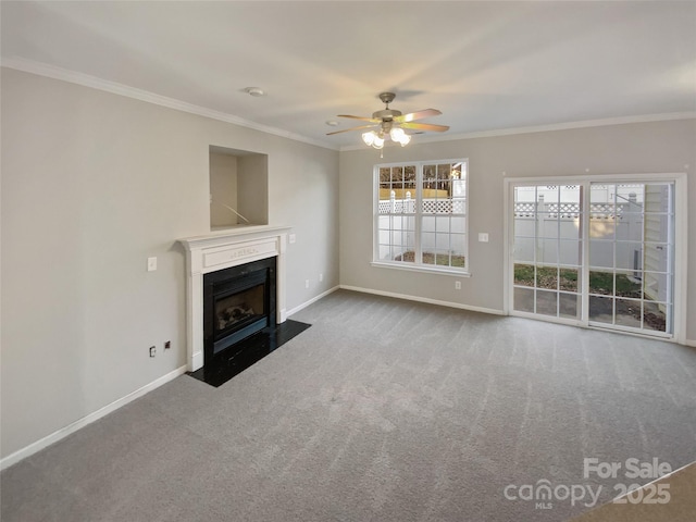 unfurnished living room featuring carpet flooring, ceiling fan, and crown molding