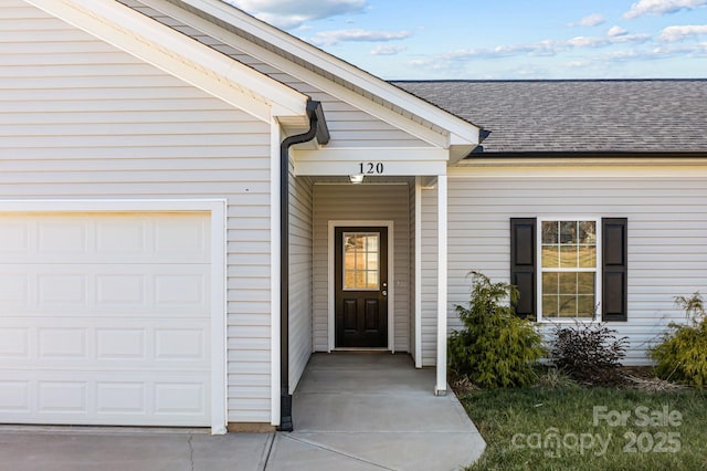 view of exterior entry with a garage