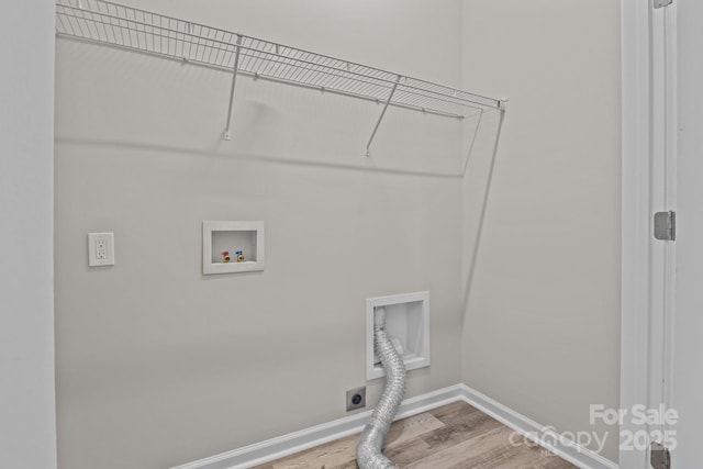 clothes washing area featuring hardwood / wood-style flooring, washer hookup, and hookup for an electric dryer