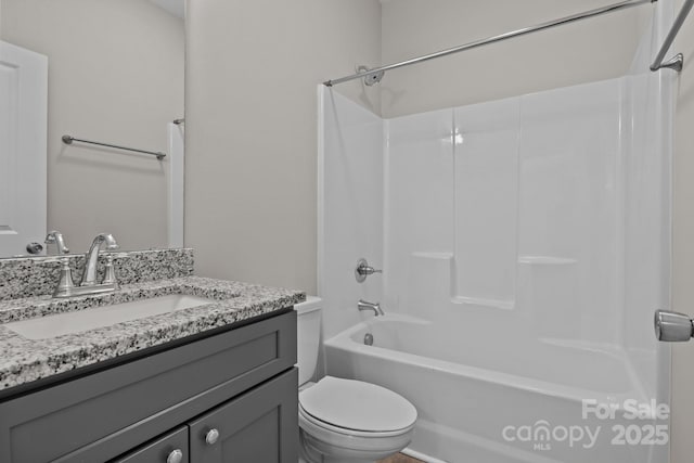 full bathroom featuring vanity, tub / shower combination, and toilet