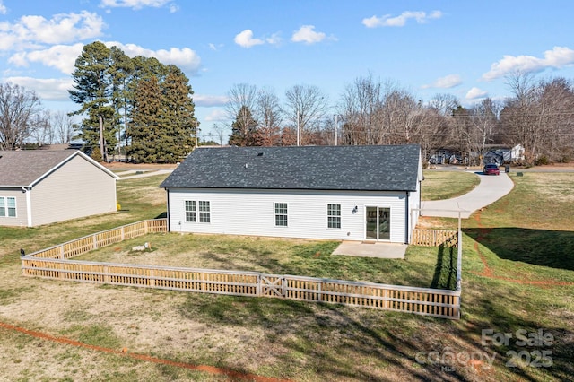 rear view of property featuring a lawn and a patio area