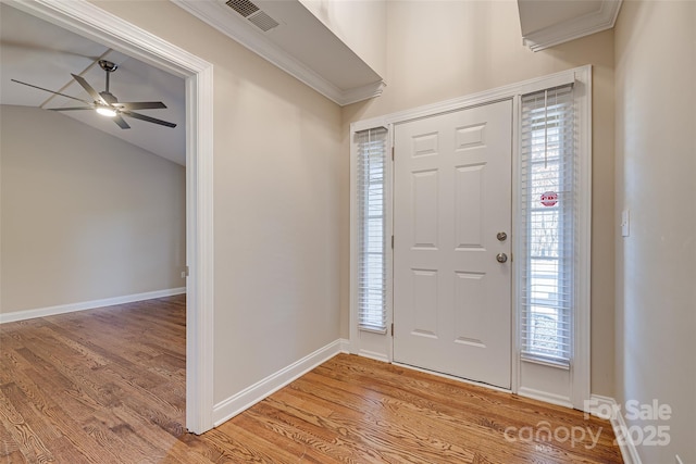 foyer entrance featuring plenty of natural light, light hardwood / wood-style floors, and lofted ceiling