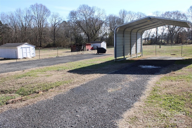 exterior space featuring a carport and a storage shed