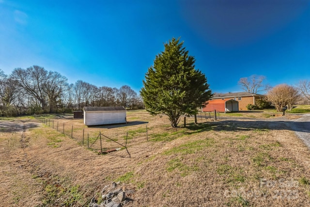 view of yard with an outbuilding and a rural view