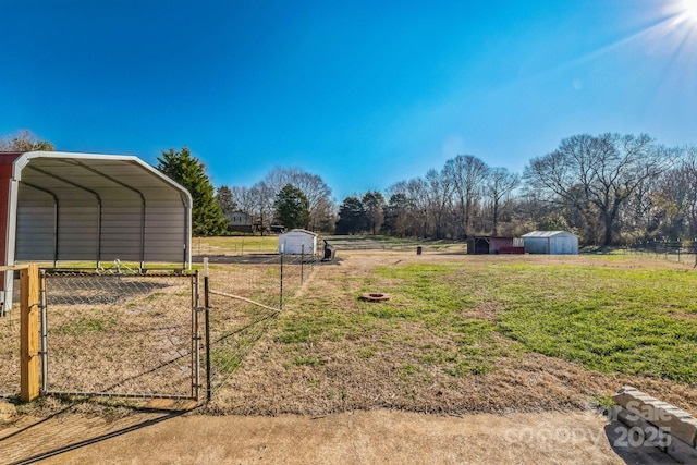 view of yard with a carport and a storage shed