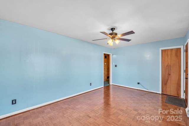 empty room with parquet flooring and ceiling fan